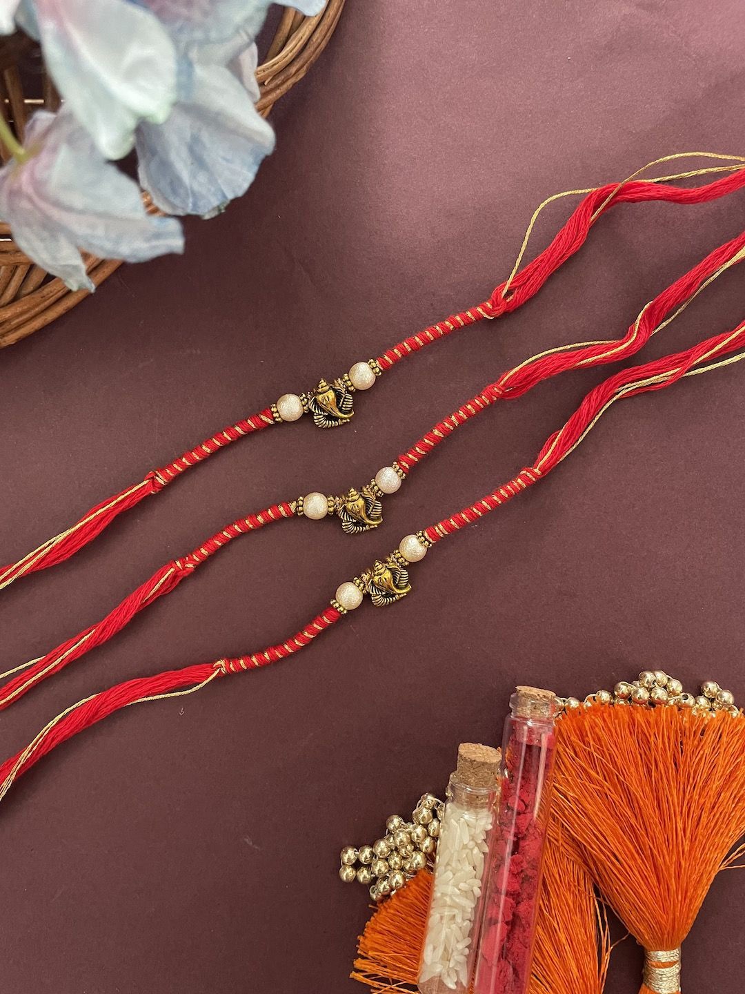 

Digital Dress Room Set Of 3 Ganesha Beaded Thread Rakhi, Red