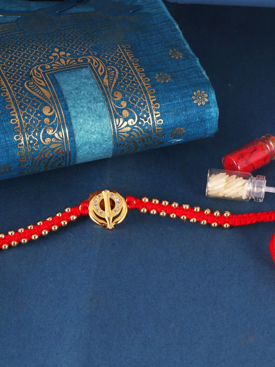 

Vighnaharta Gold and Rhodium Plated Stone Studded Thread Rakhi, Red