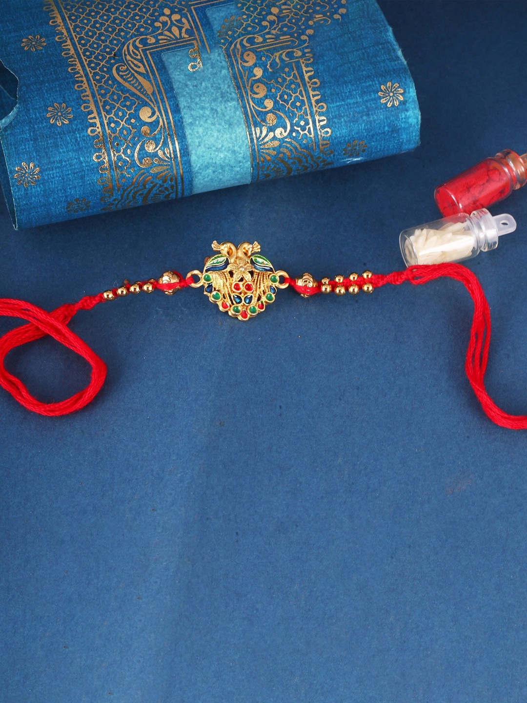 

Vighnaharta Gold and Rhodium Plated Peacock Beaded Thread Beaded Rakhi, Red