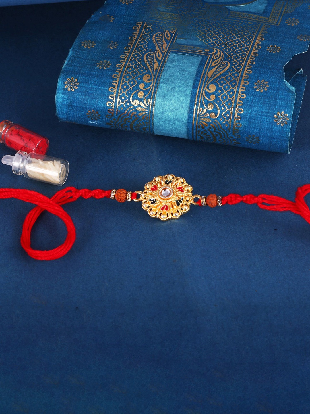 

Vighnaharta Gold and Rhodium Plated Flower Thread Rakhi with Roli Chawal, Red