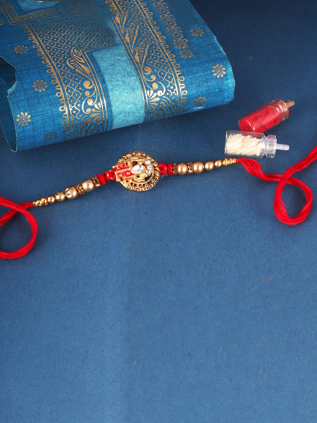 

Vighnaharta Gold and Rhodium Plated Swastik Thread Rakhi, Red