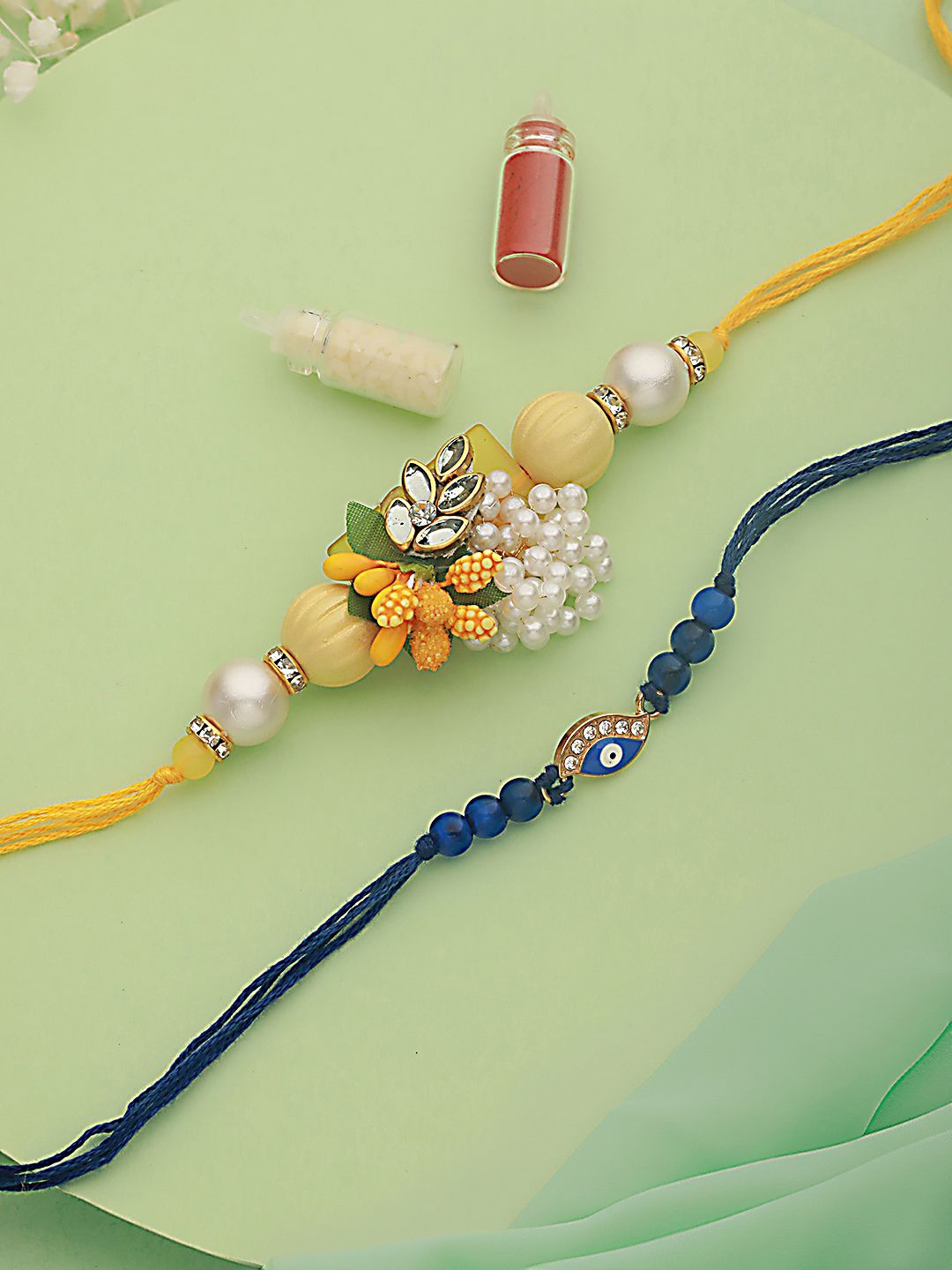 

Anouk Yellow Set of 2 Floarl & Evil Eye Beaded Rakhi with Roli Chawal