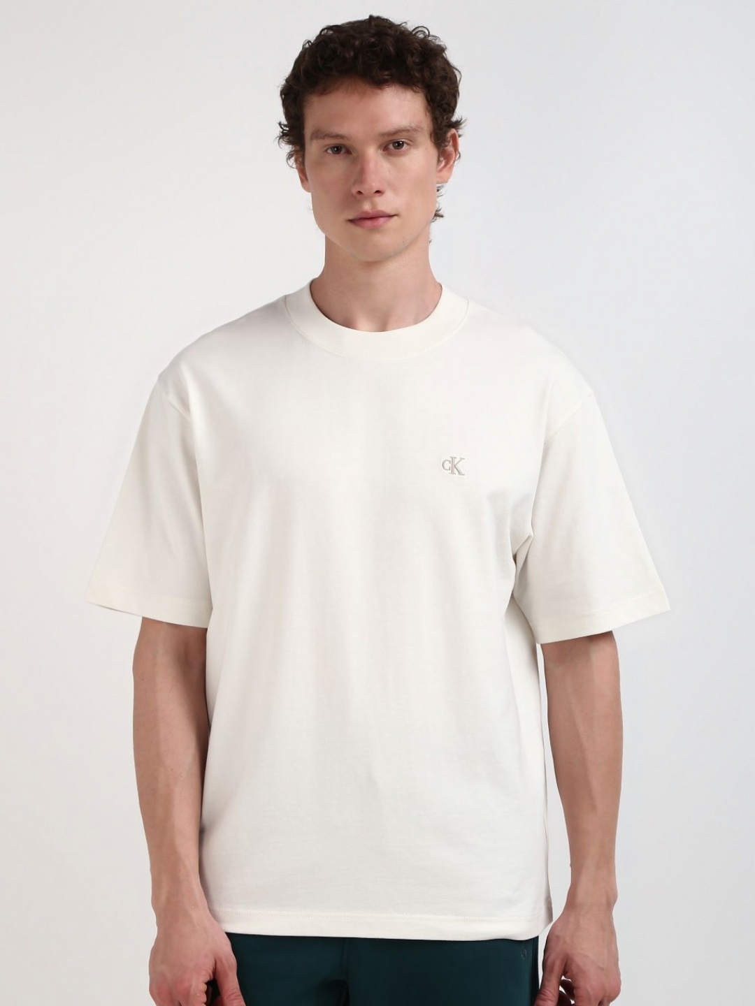 

Calvin Klein Jeans Men Solid Round Neck Cotton Relaxed Fit Tshirt, Off white