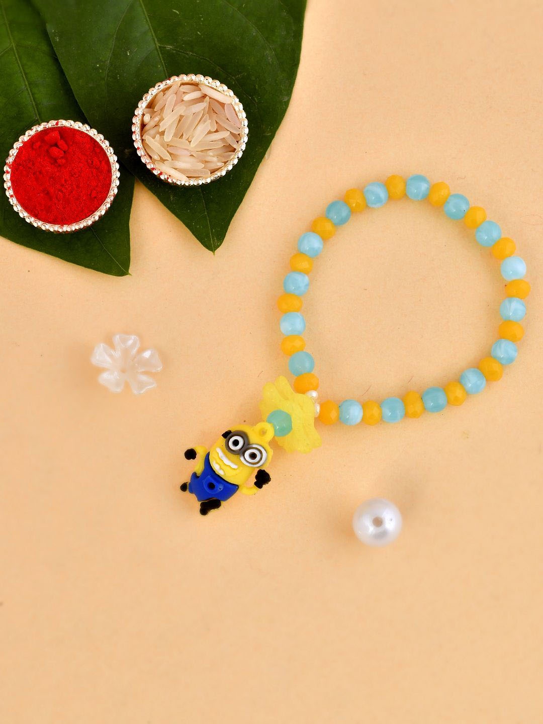 

Kook N Keech Yellow Minion Beaded Elasticated Rakhi With Roli Chawal & Greetings Card