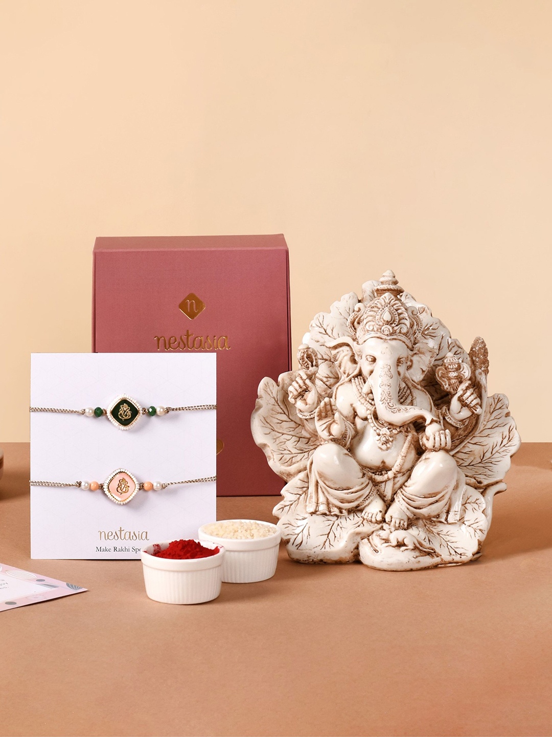 

Nestasia Set Of 3 Rakhi With Divine Ganesh Idol Roli Chawal & Greeting Card, White
