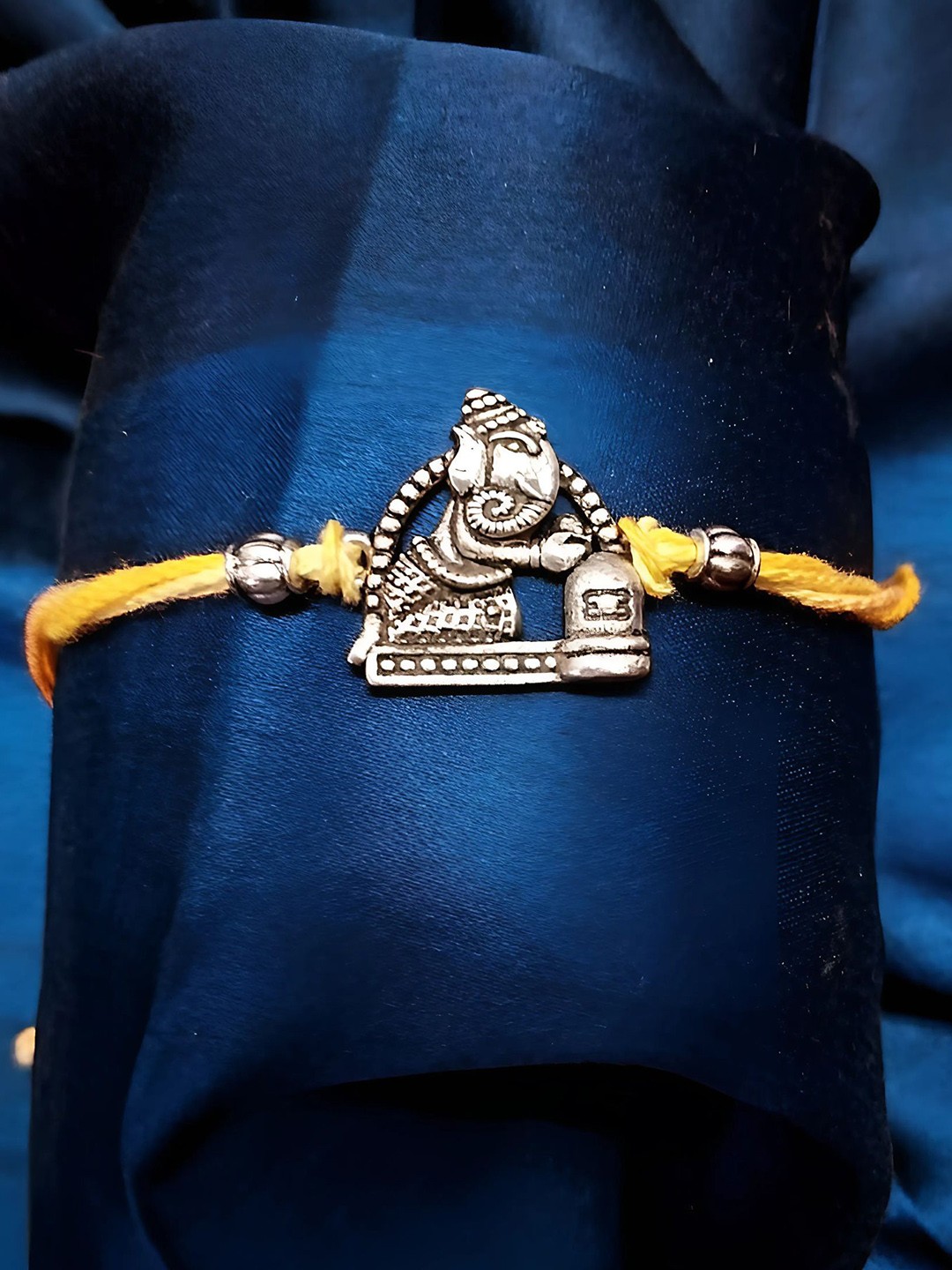 

Sangria Silver Plated Ganesha Thread Rakhi