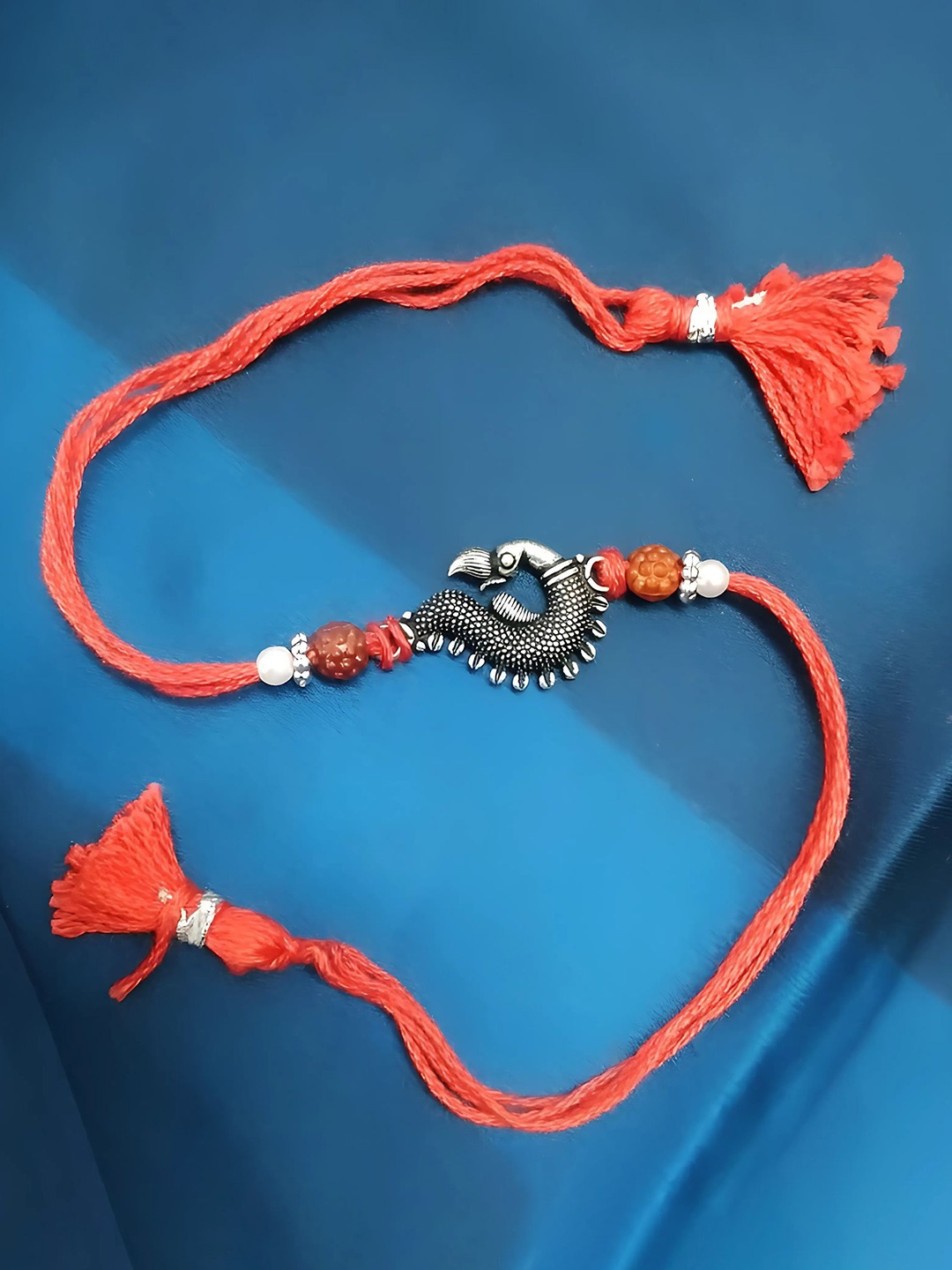 

Sangria Silver Plated Peacock Shape Thread Rakhi