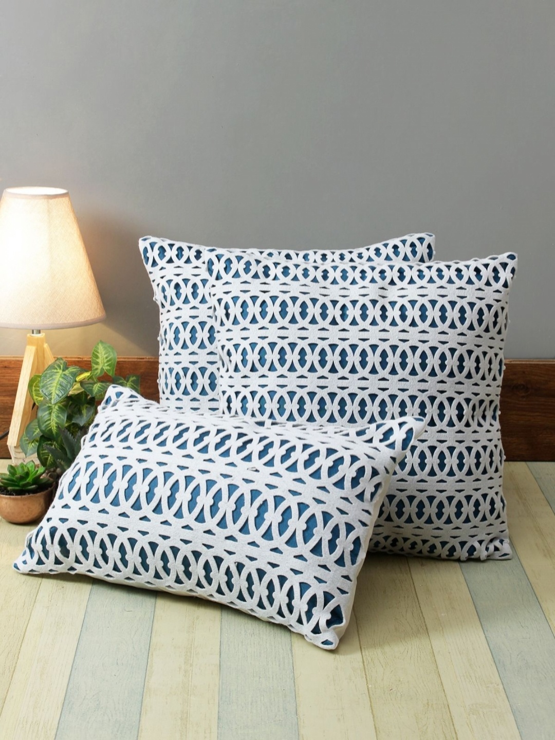 

Myntra Elegant Homes Blue & White 3 Pieces Ethnic Motifs Laser Cut Square Cushion Covers