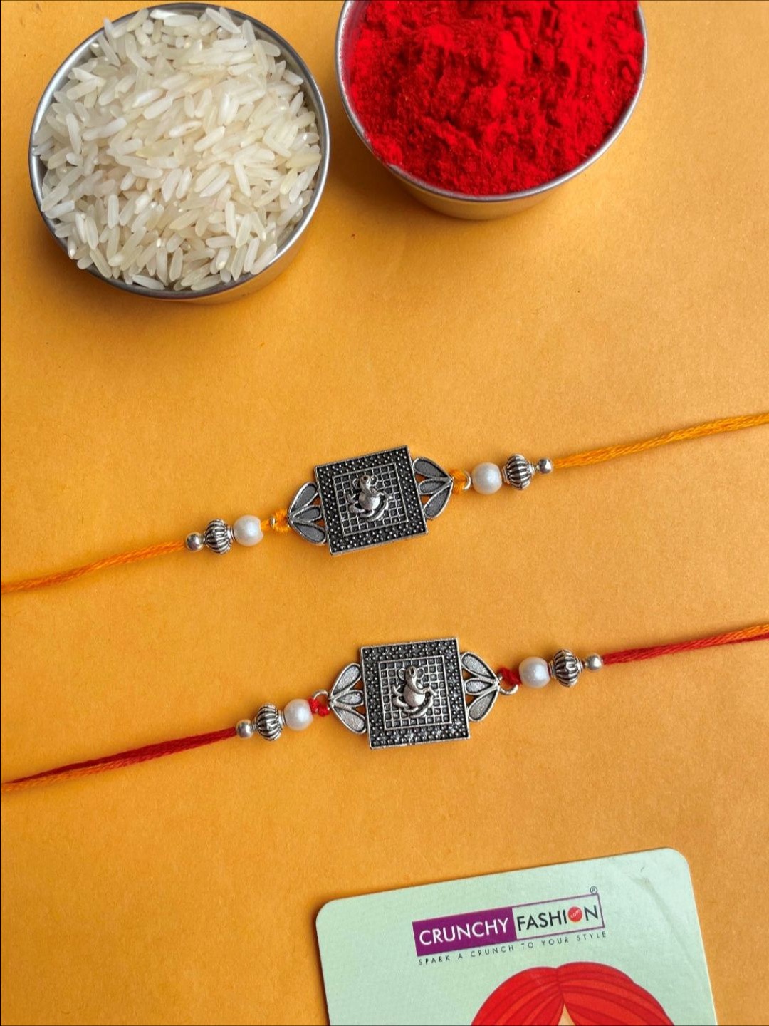 

Crunchy Fashion Set Of 2 Lord Ganesha Square Oxidised Thread Rakhi With Roli Chawal, Red