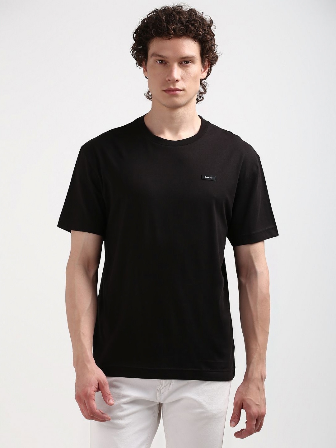 

Calvin Klein Jeans Men Solid Round Neck Pure Cotton Relaxed Fit Tshirt, Black