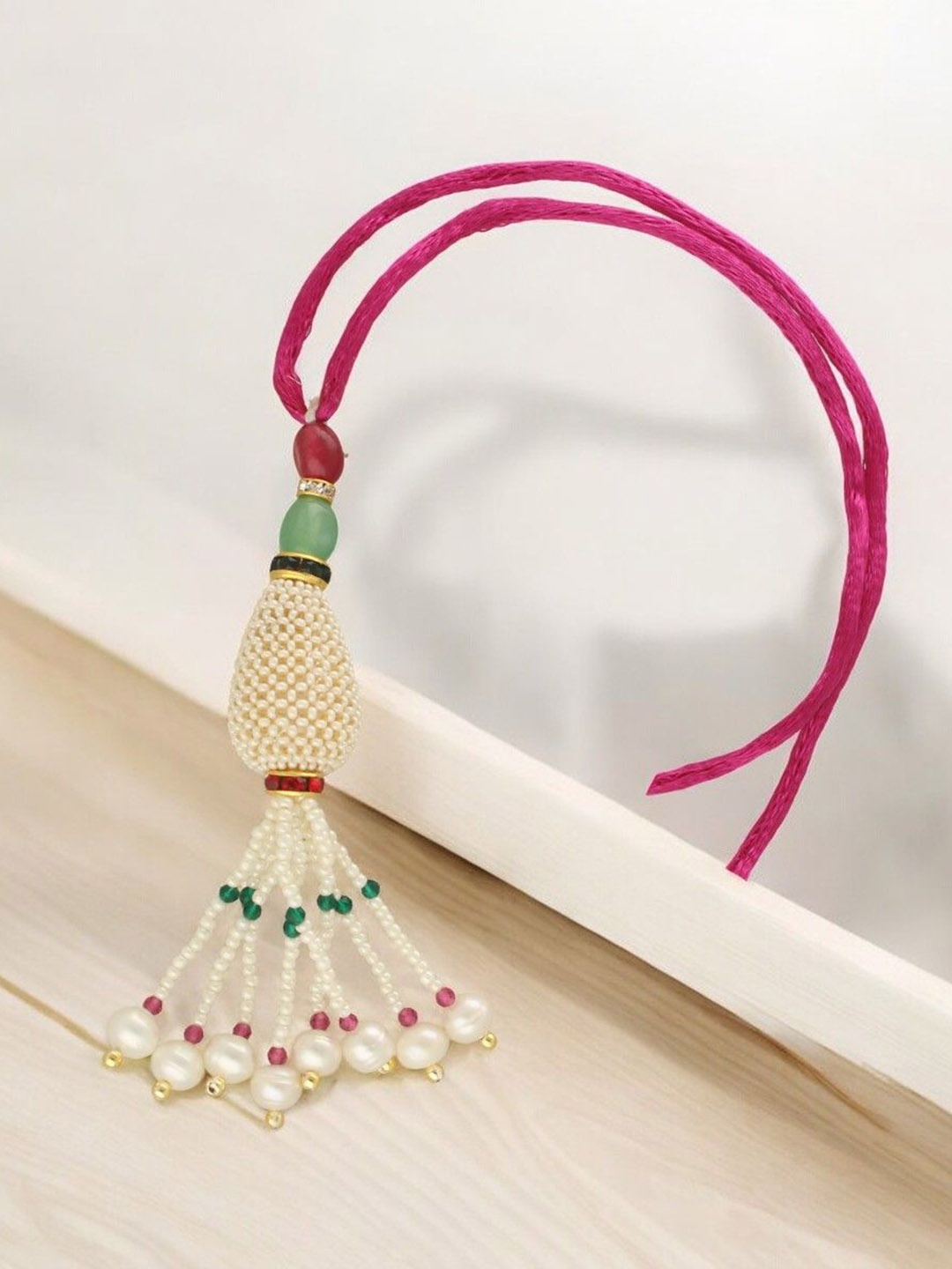 

Sri Jagdamba Pearls Dealer Fresh Water Pearl Beaded Lumba Thread Rakhi, White