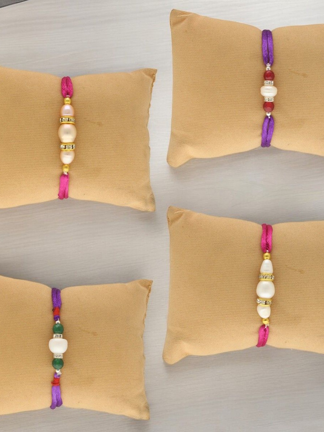 

Sri Jagdamba Pearls Dealer Set Of 4 Fresh Water Pearl Beaded Thread Rakhis, White