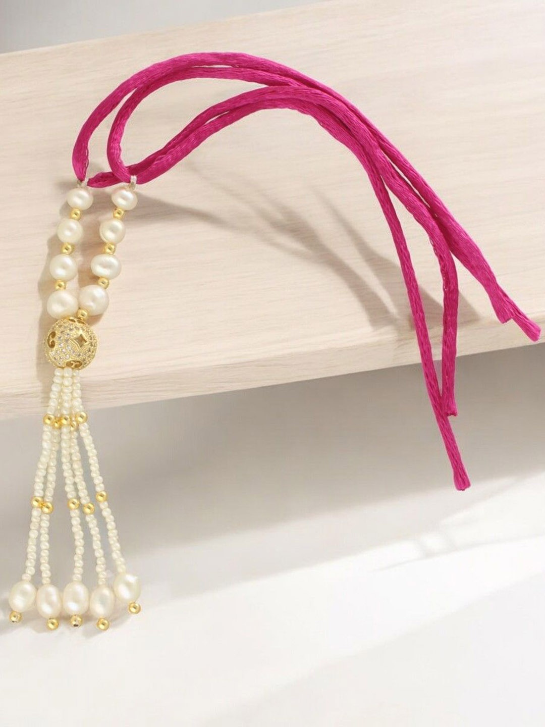 

Sri Jagdamba Pearls Dealer Fresh Water Pearls Lumba Rakhi, White