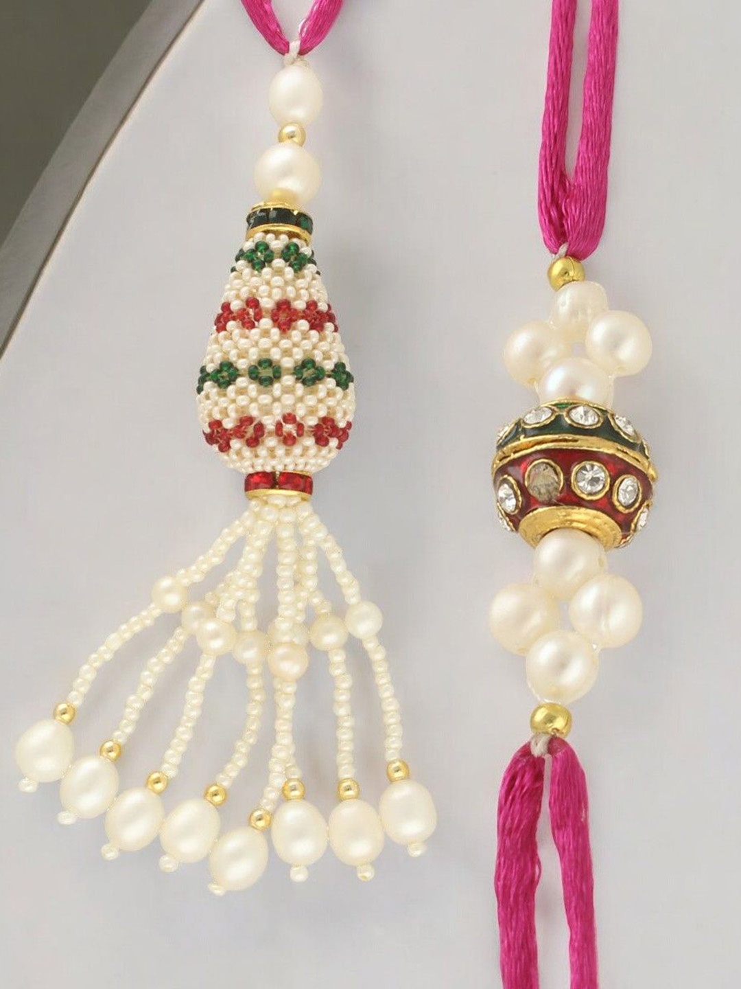 

Sri Jagdamba Pearls Dealer Set of 2 Stone Studded Pearl Beaded Lumab & Thread Rakhis, White