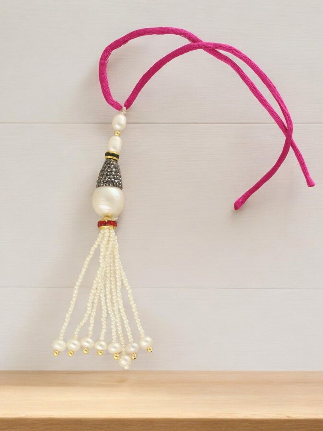 

Sri Jagdamba Pearls Dealer Grandiose Designer Fresh Water Pearls Lumba Rakhi, Pink