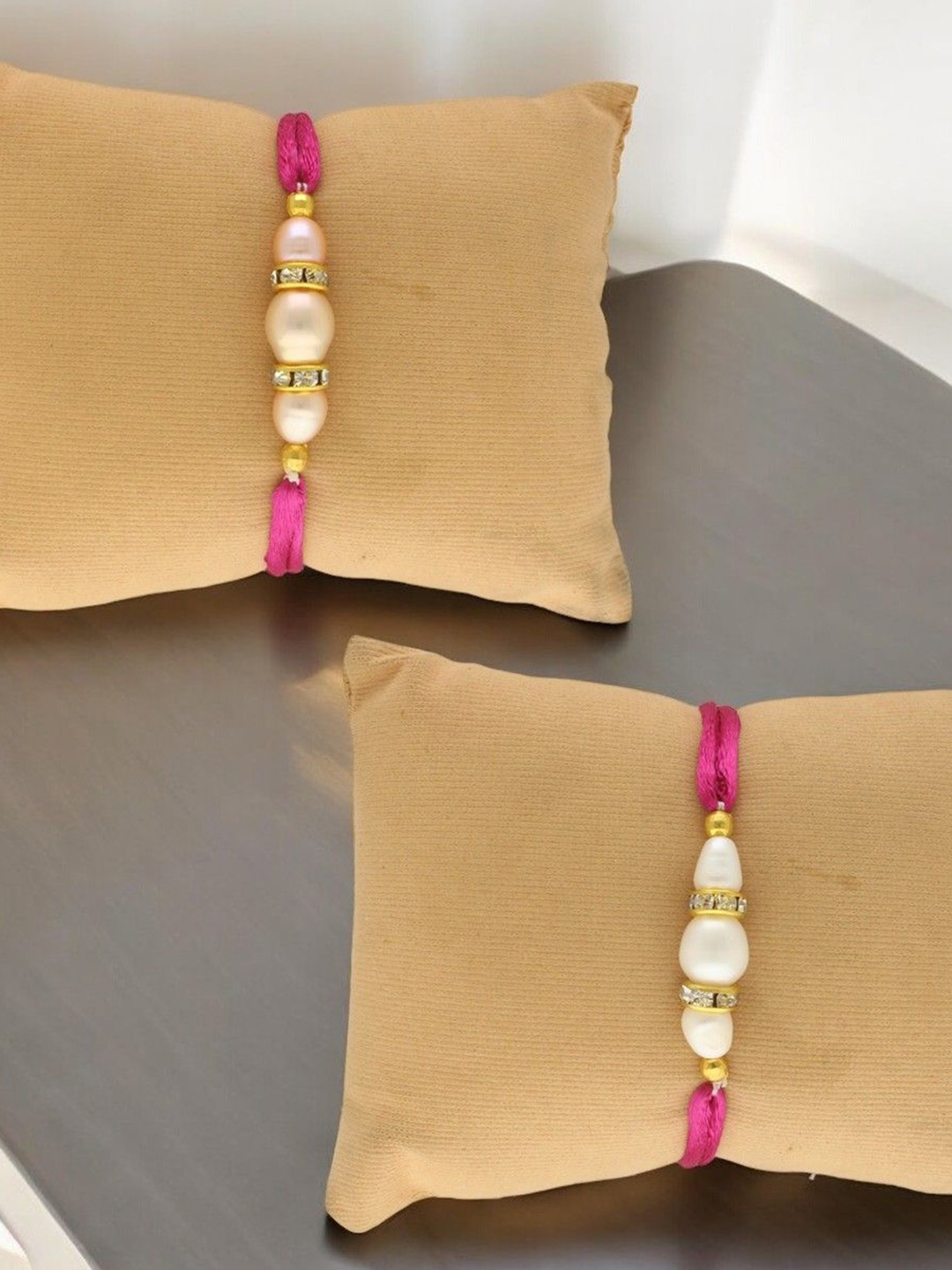 

Sri Jagdamba Pearls Dealer Set Of 2 Fresh Water Pearls Thread Rakhis, Pink