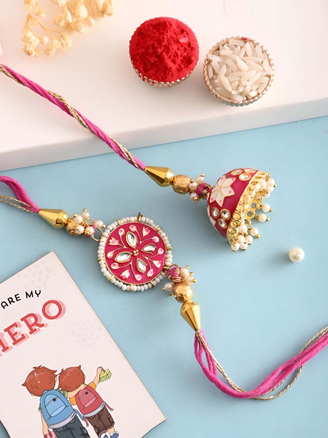 

Ascension Set Of 3 Rakhi With Fridge Magnet & Roli Chwal, Pink