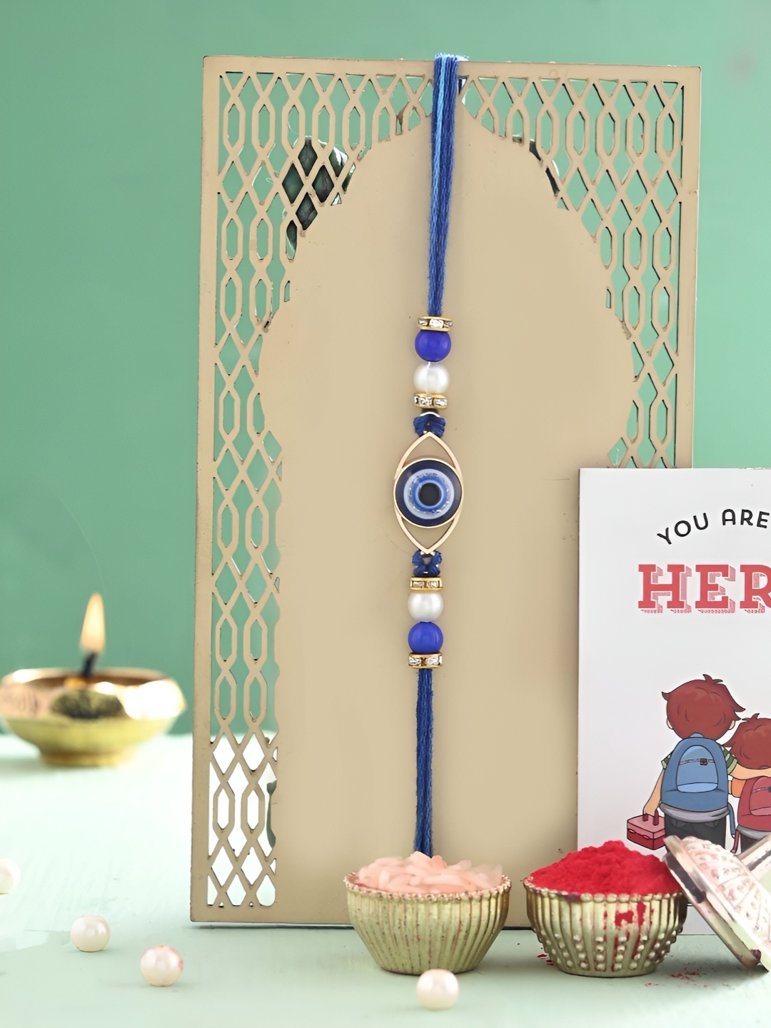 

Ascension Set Of 2 Rakhi With Fridge Magnet & Roli Chwal, Blue