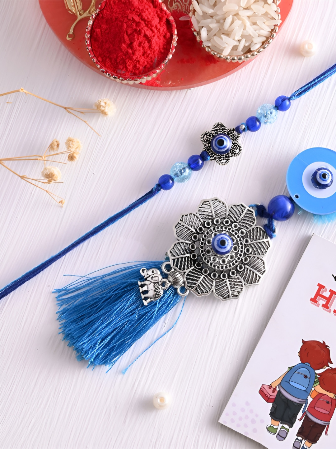

Ascension Set Of 3 Rakhi With Fridge Magnet & Roli Chwal, Blue