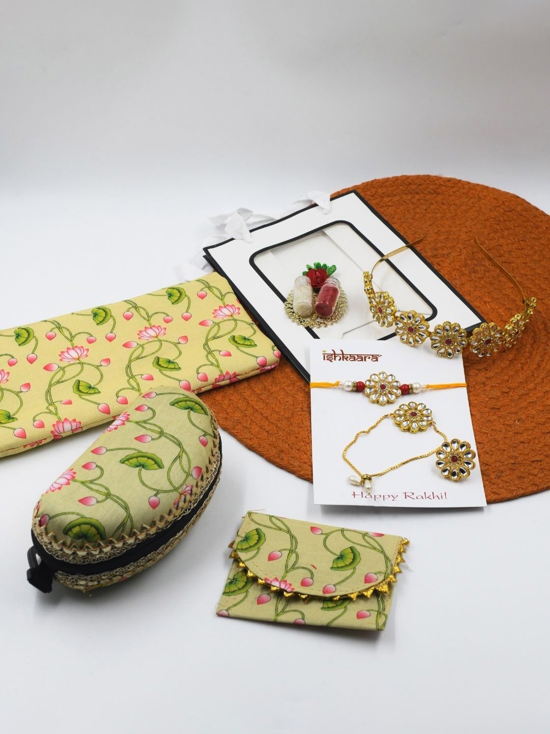 

ISHKAARA Set Of 7 Bhaiya Bhabhi Rakhi With Floral Printed Pouches & Jewellery, Gold