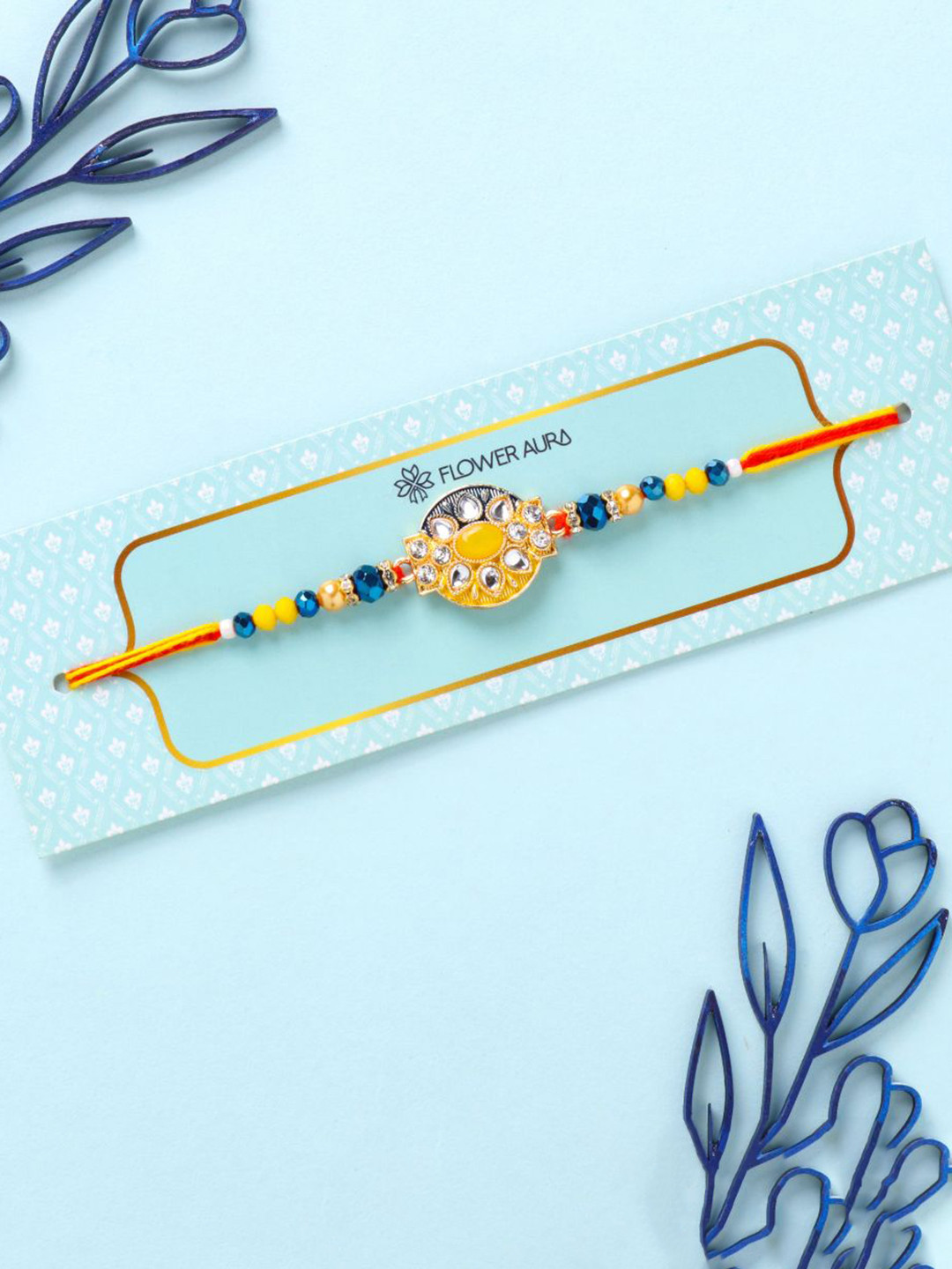 

Floweraura Stone Studded & Beaded Thread Rakhi With Roli Chawal, Yellow
