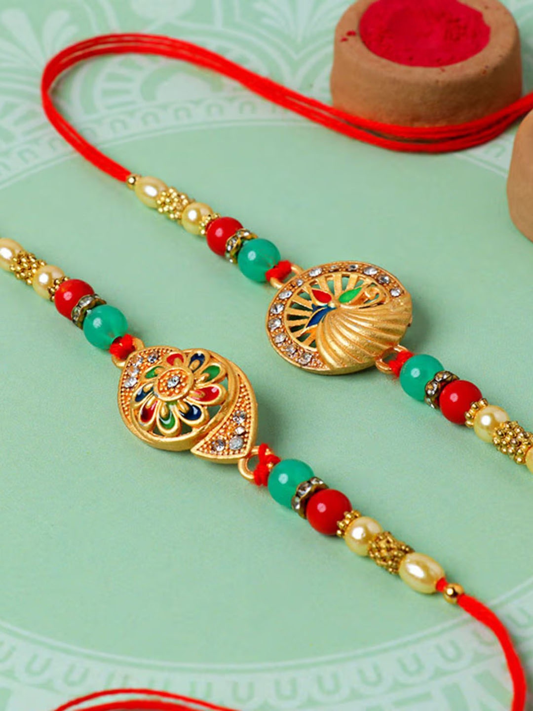 

Floweraura Set Of 2 Stone Studded & Beaded Thread Rakhi With Roli Chawal, Red
