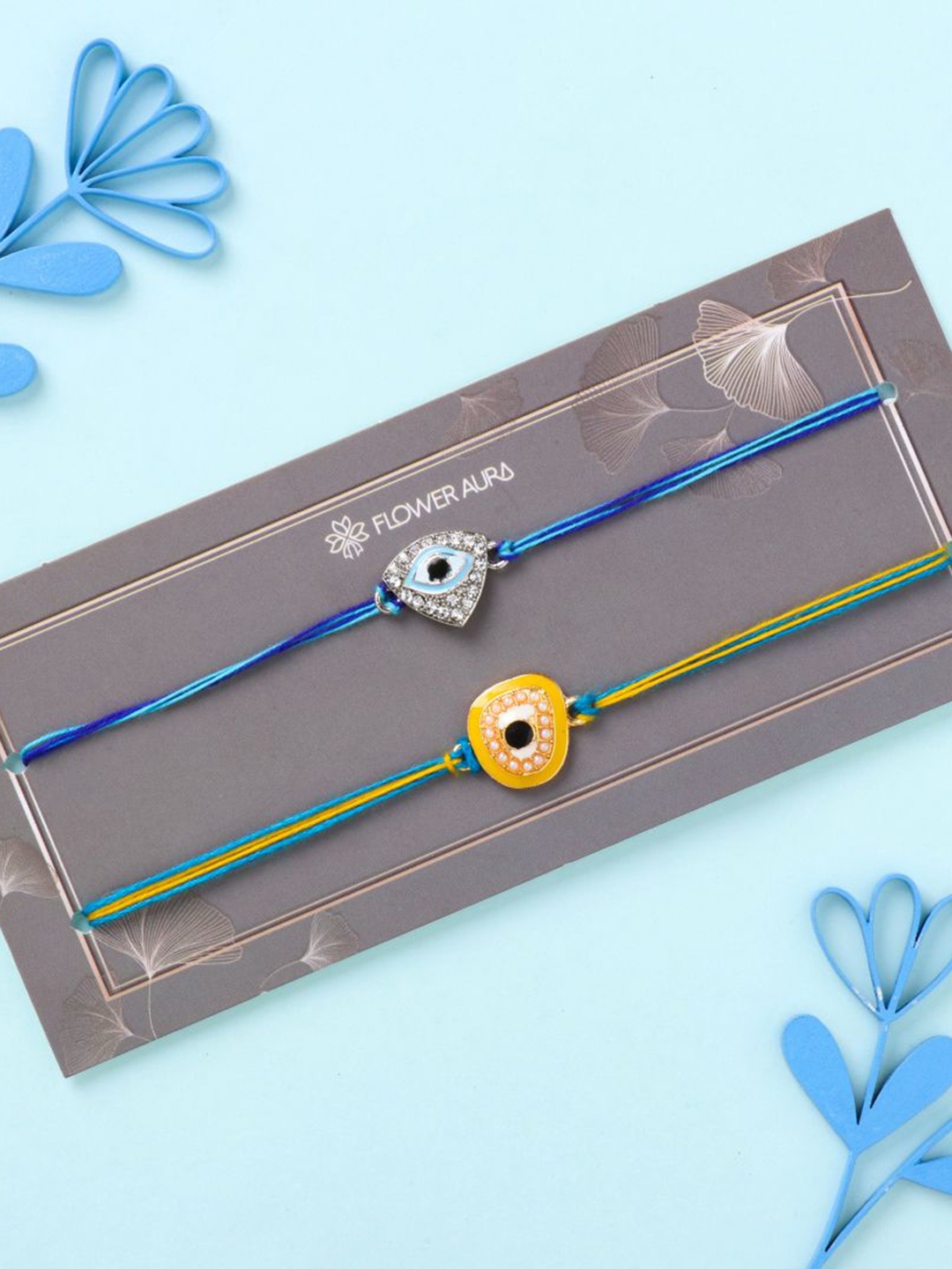 

Floweraura Set Of 2 Evil Eye Stone Studded & Beaded Thread Rakhis With Roli Chawal, Blue