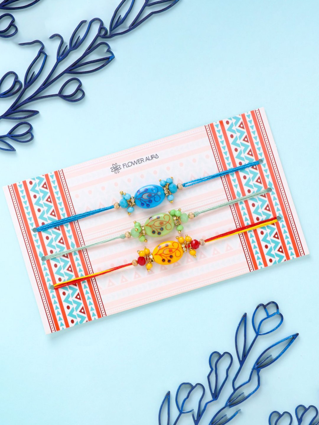 

Floweraura Set Of 3 Floral Beaded Thread Rakhis With Roli Chawal, Blue