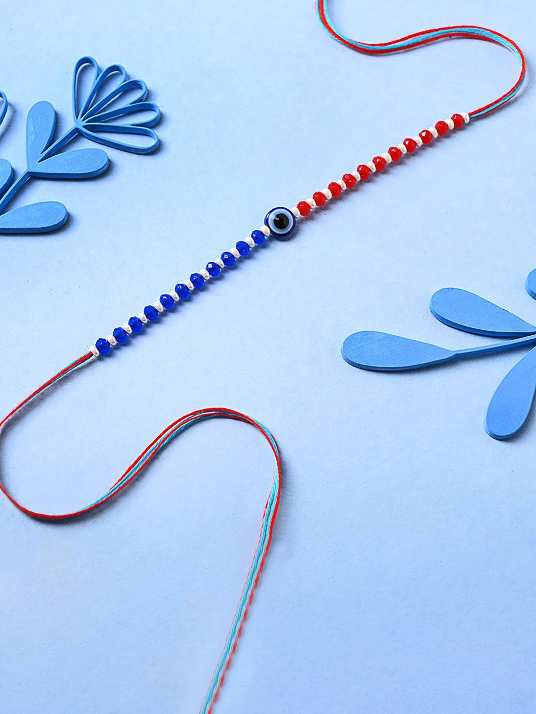 

Floweraura Evil Eye Beaded Thread Rakhi With Roli Chawal, Blue