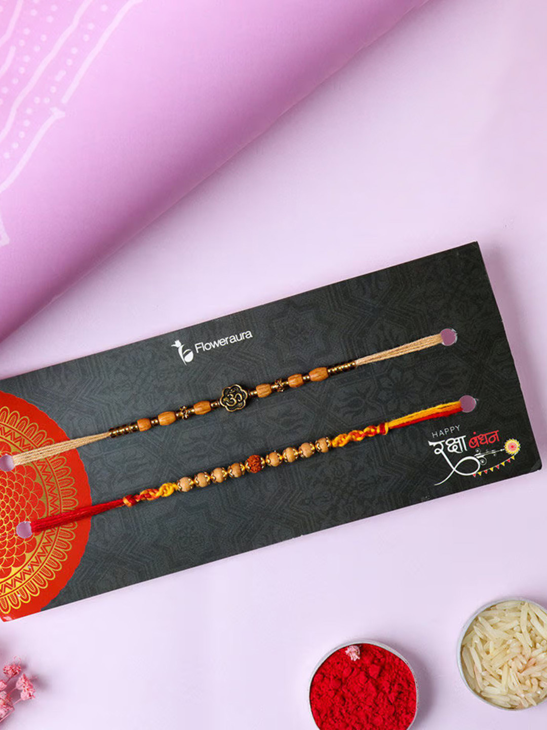 

Floweraura Set Of 2 Om Rudraksha Thread Rakhi With Roli & Chawal, Red