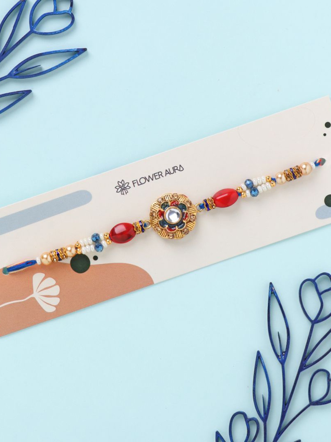 

Floweraura Stone Studded & Beaded Thread Rakhi With Roli Chawal, Blue