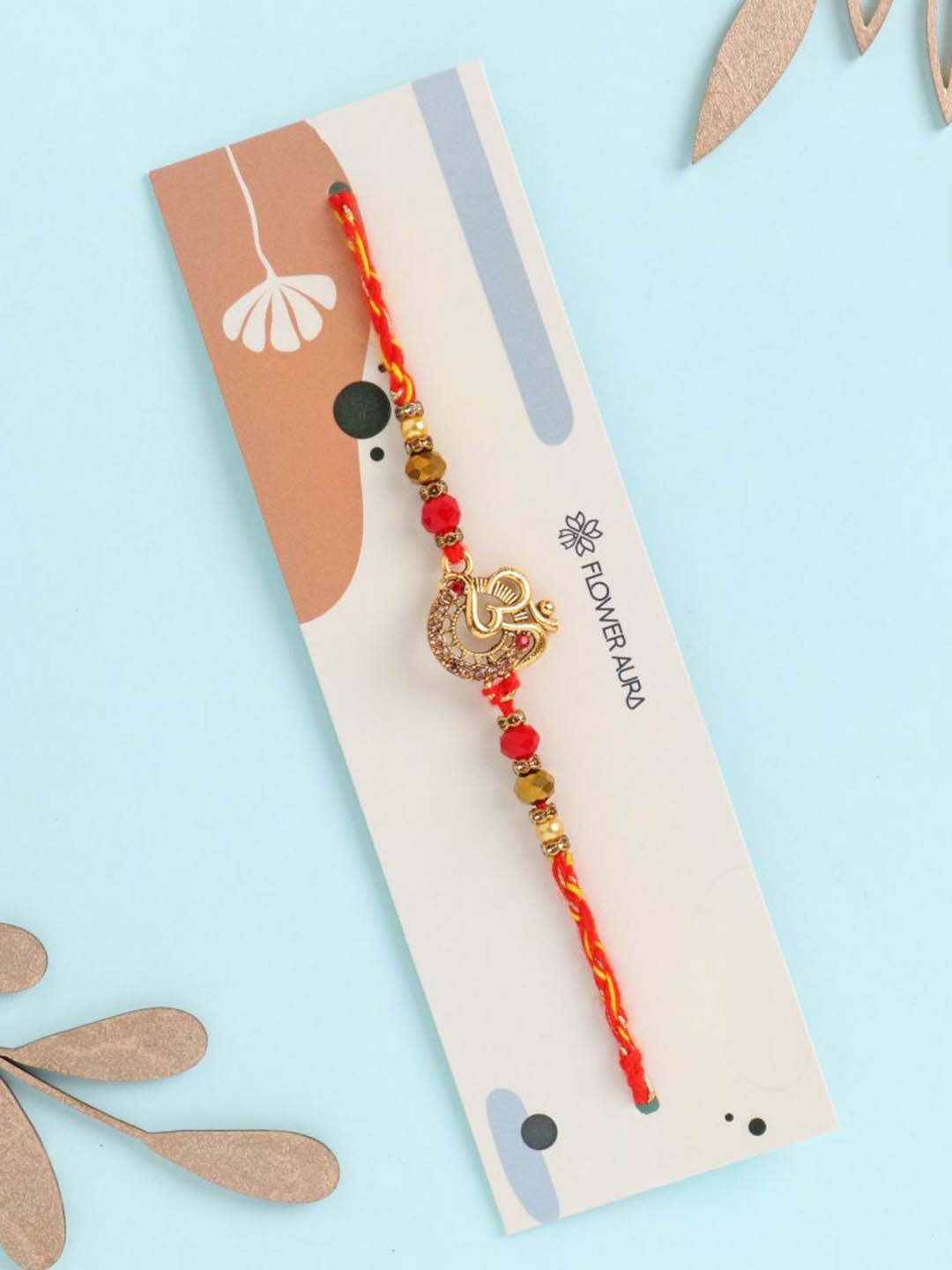 

Floweraura Om Charm Pearl Thread Rakhi with Roli Chawal, Red