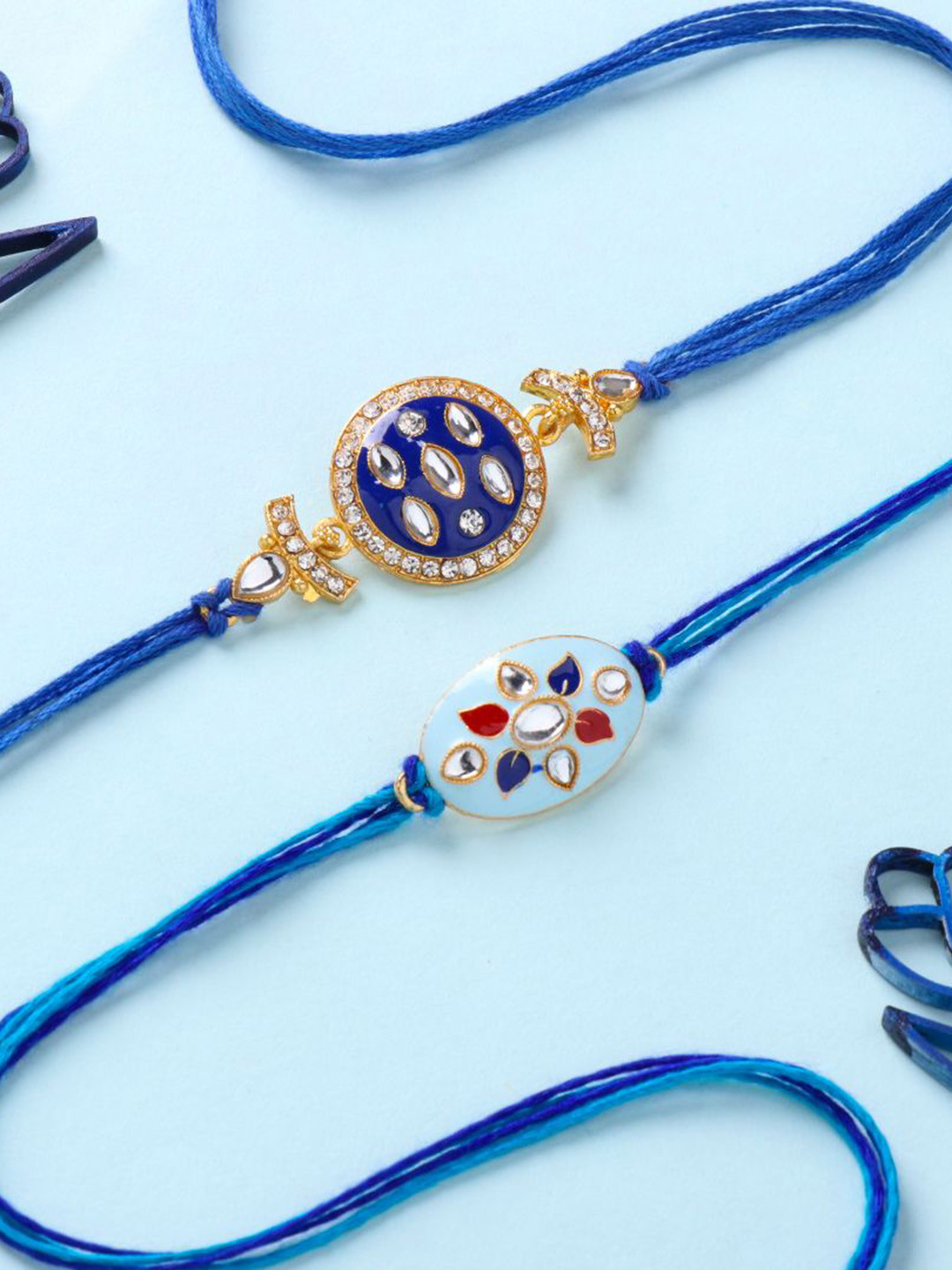 

Floweraura Set Of 2 Stone Studded Thread Rakhi With Roli Chawal, Blue