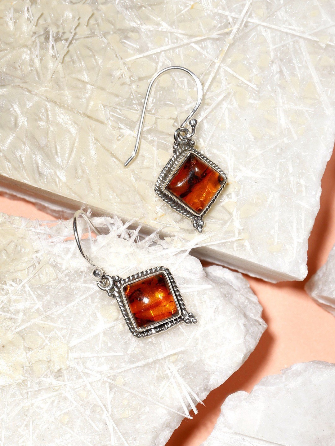 

Exotic India Diamond Shaped Sterling Silver Amber Hook Earrings, Red