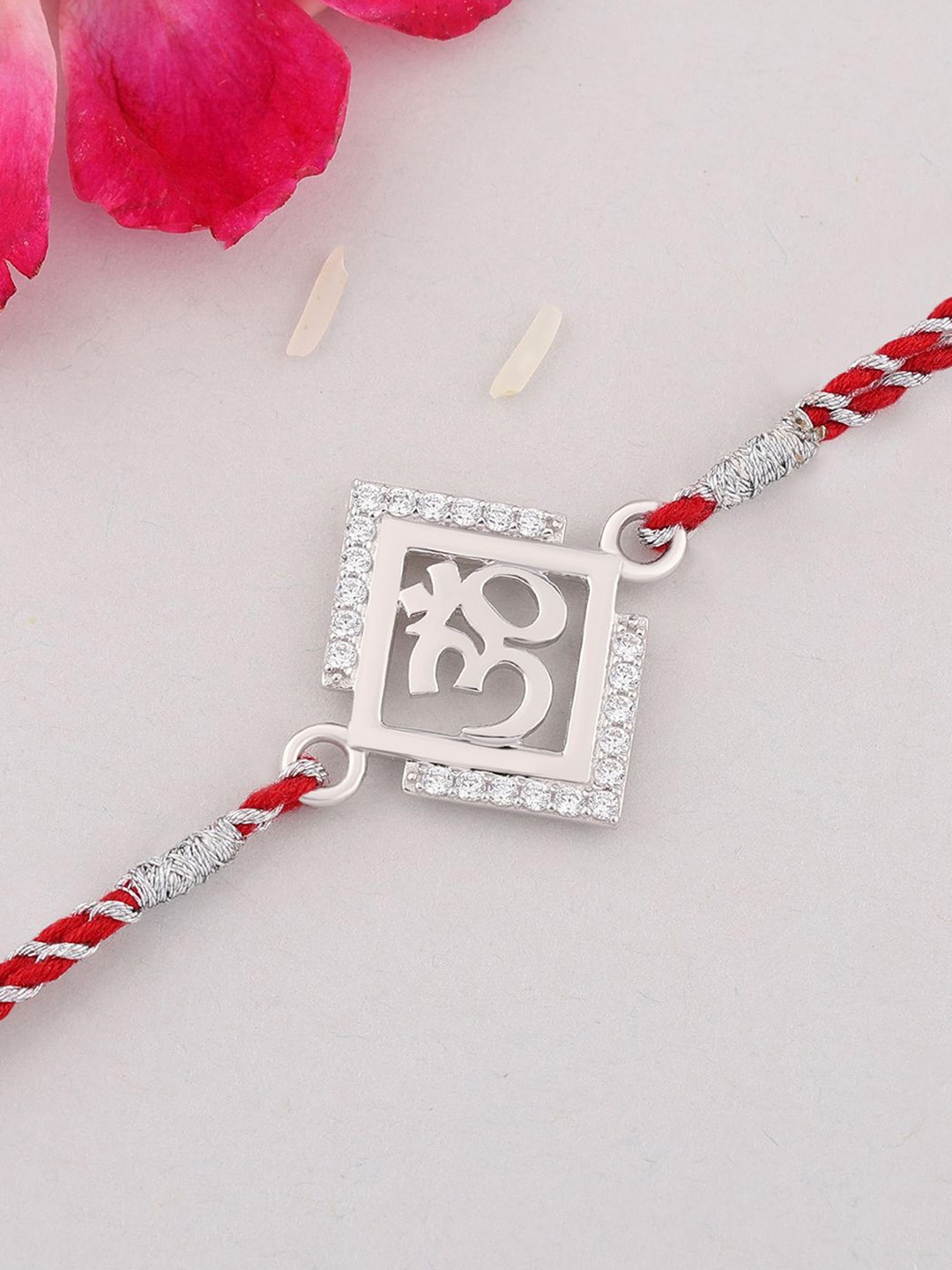 

Ornate Jewels 925 Silver American Diamond Om Thread Rakhi With Roli Chawal & Greting Card