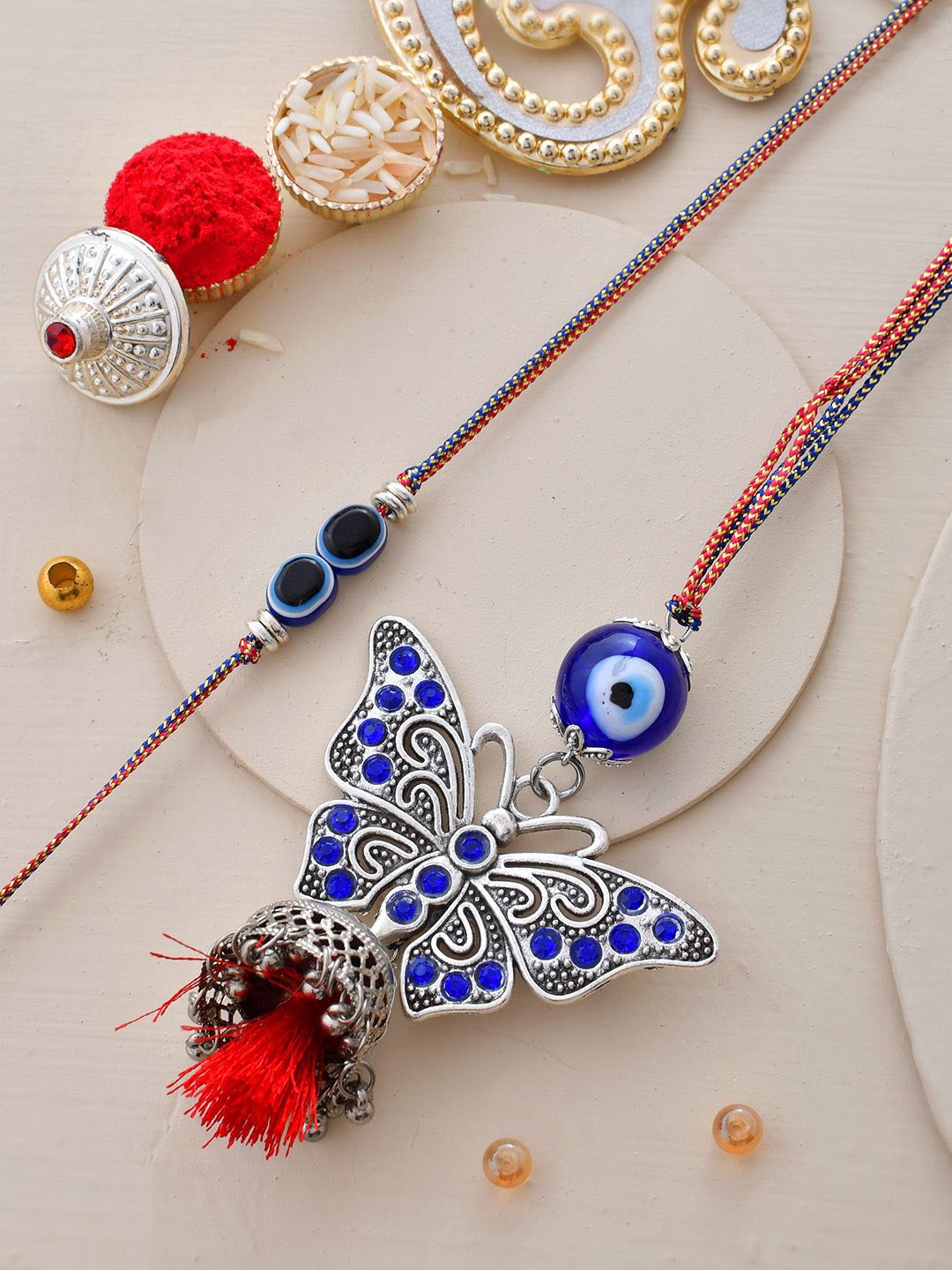 

Sangria Oxidised Evil-Eye Butterfly Patterned Bhaiya Bhabhi Rakhi With Roli Chawal, Silver