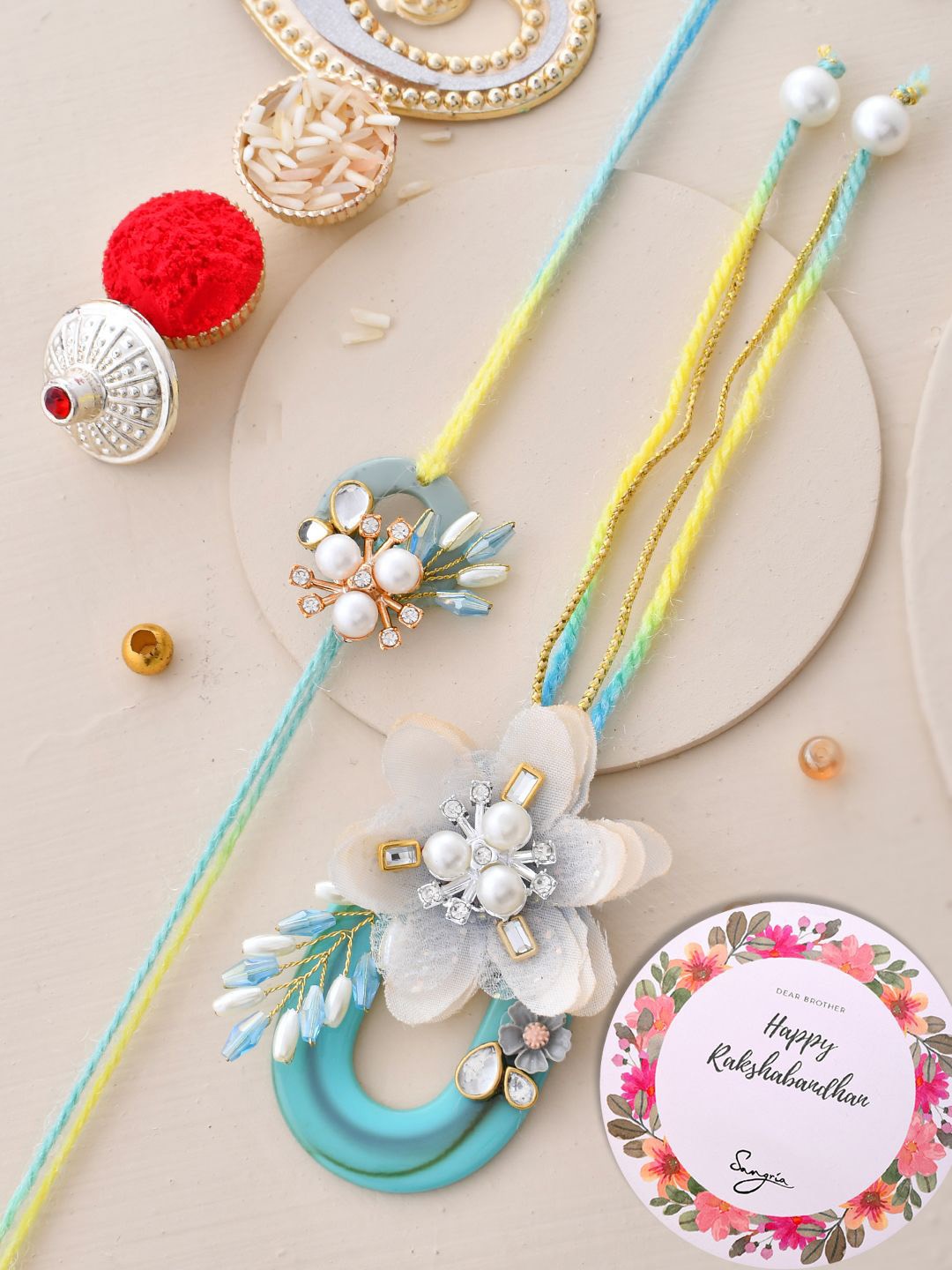

Sangria Blue Set of 2 Pearl Beaded Lumbs & Thread Rakhi With Roli Chawal