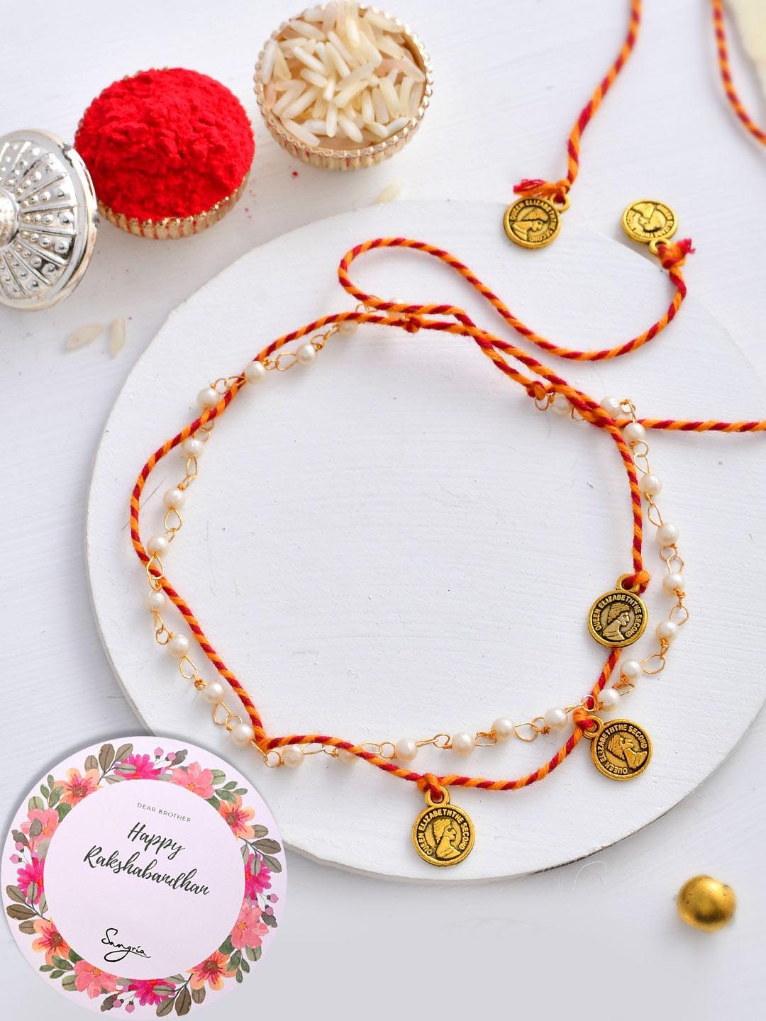 

Sangria Gold-toned Pearl Beaded Thread Rakhis With Roli Chawal & Greeting Card