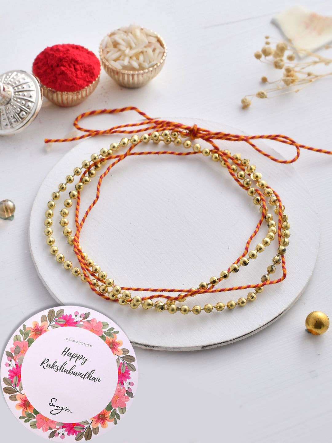 

Sangria Red Set of 3 Beaded Thread and Wraparound Rakhis With Greeting Card & Roli Chawal