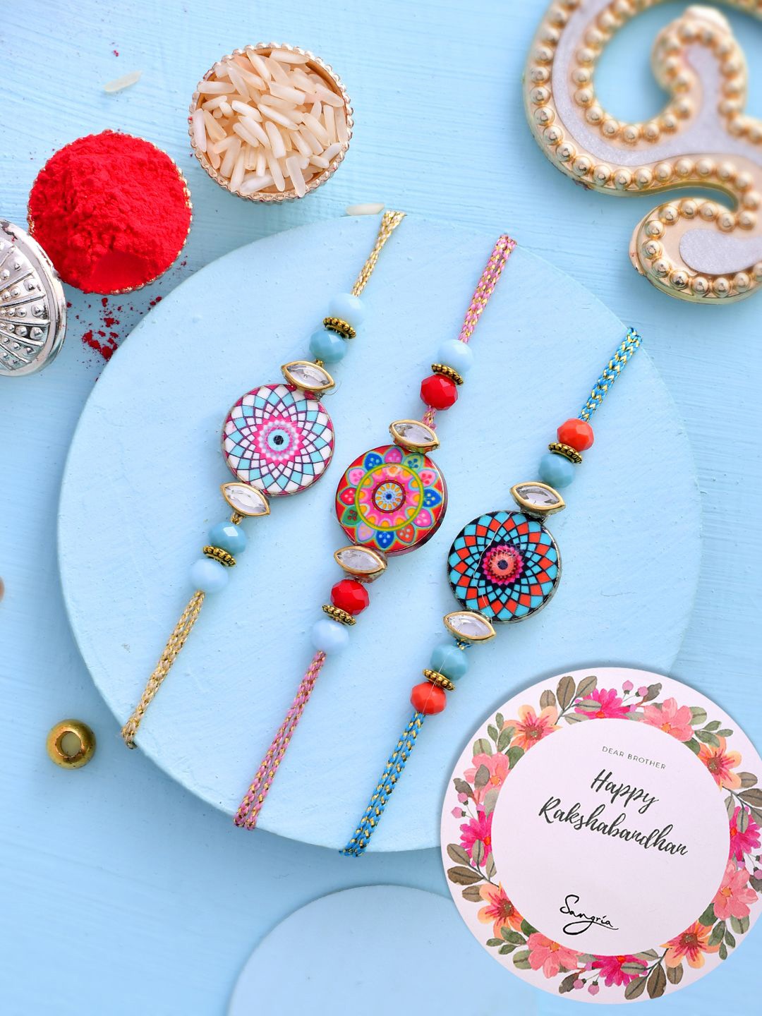 

Sangria Blue Set of 3 Mandala Art Work Thread Rakhis Greeting Card & Roli Chawal
