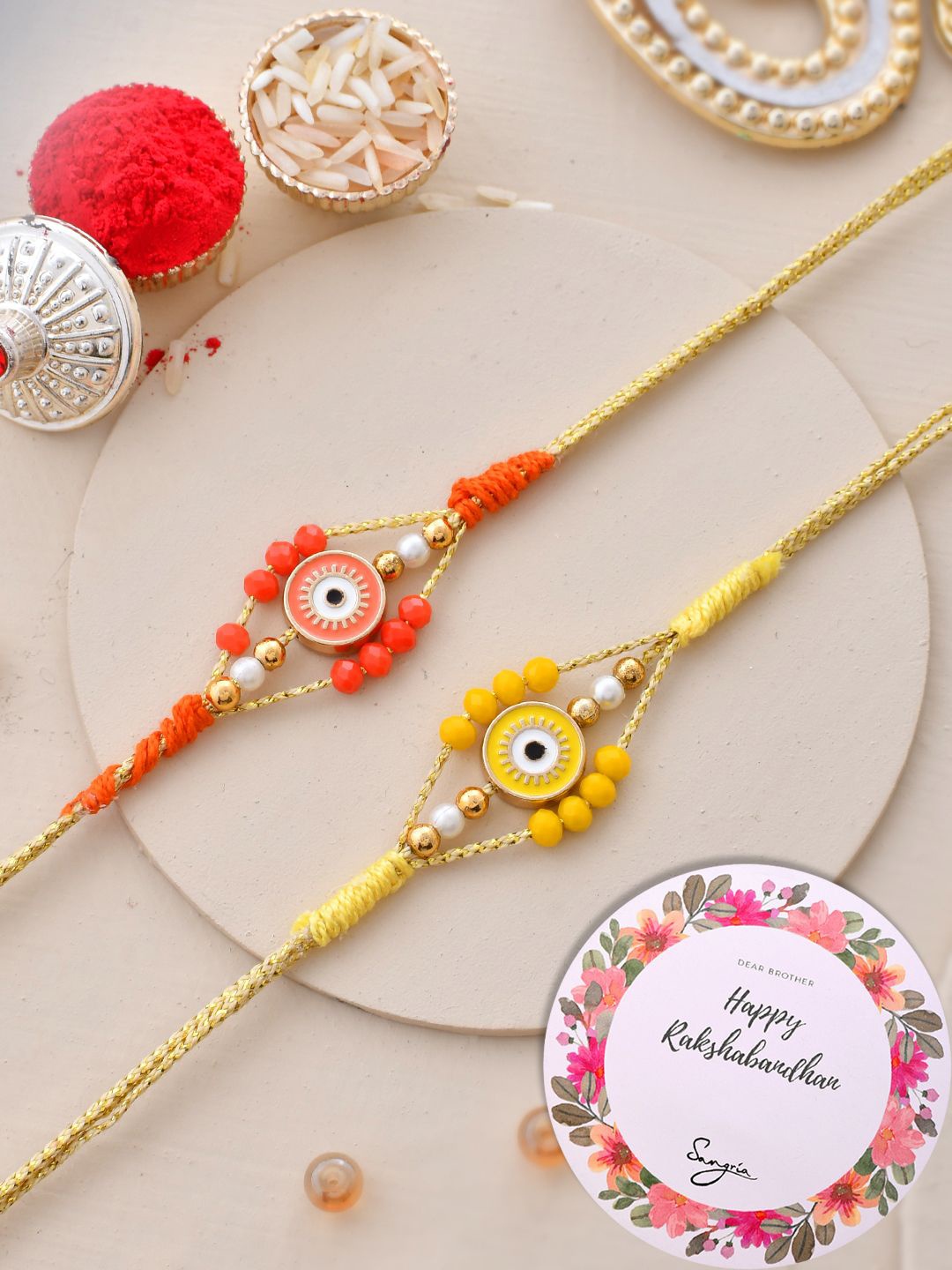 

Sangria Set Of 2 Evil-Eye Rakhi With Greeting Card & Roli Chawal, Gold