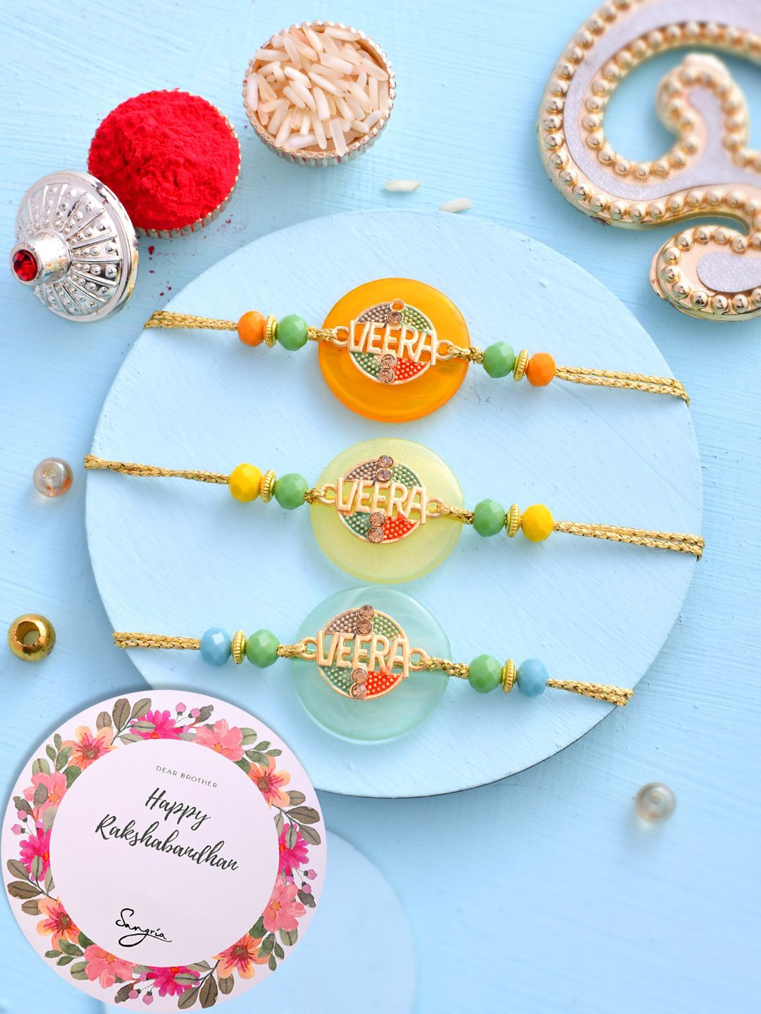 

Sangria Orange Set of 3 Beaded Thread Rakhis With Greeting Card & Roli Chawal