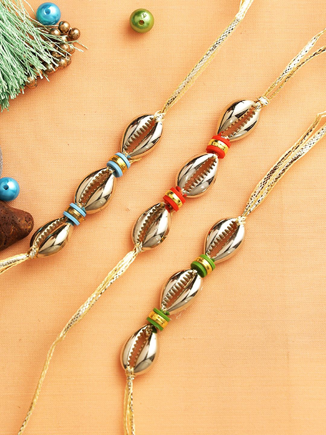 

Sangria Gold-toned Set of 3 Shell Beaded Thread Rakhis With Greeting Card & Roli Chawal