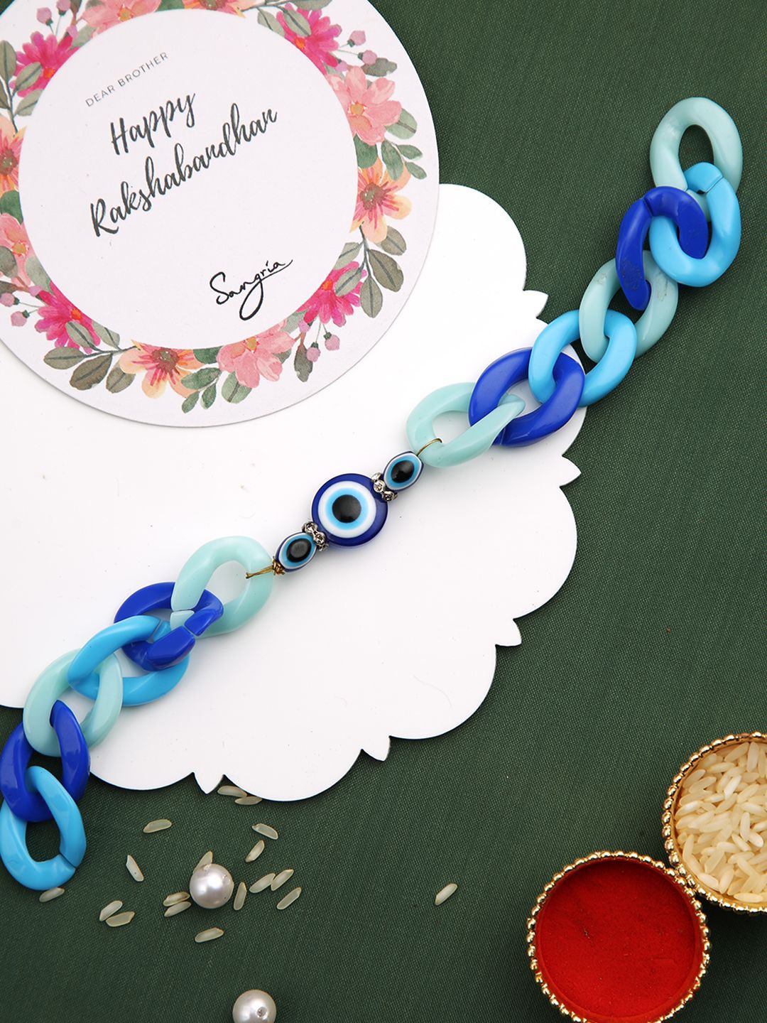 

Sangria Evil-Eye Charm Bracelet Rakhi With Roli Chawal & Greeting Card, Blue