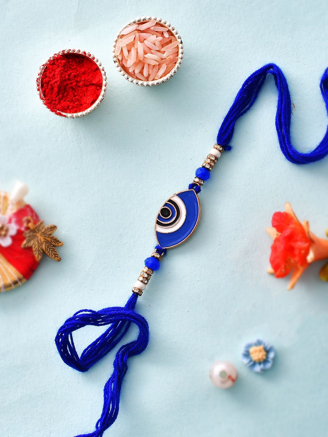 

Sangria Blue Evil Eye Thread Rakhi With Greeting Card & Roli Chawal