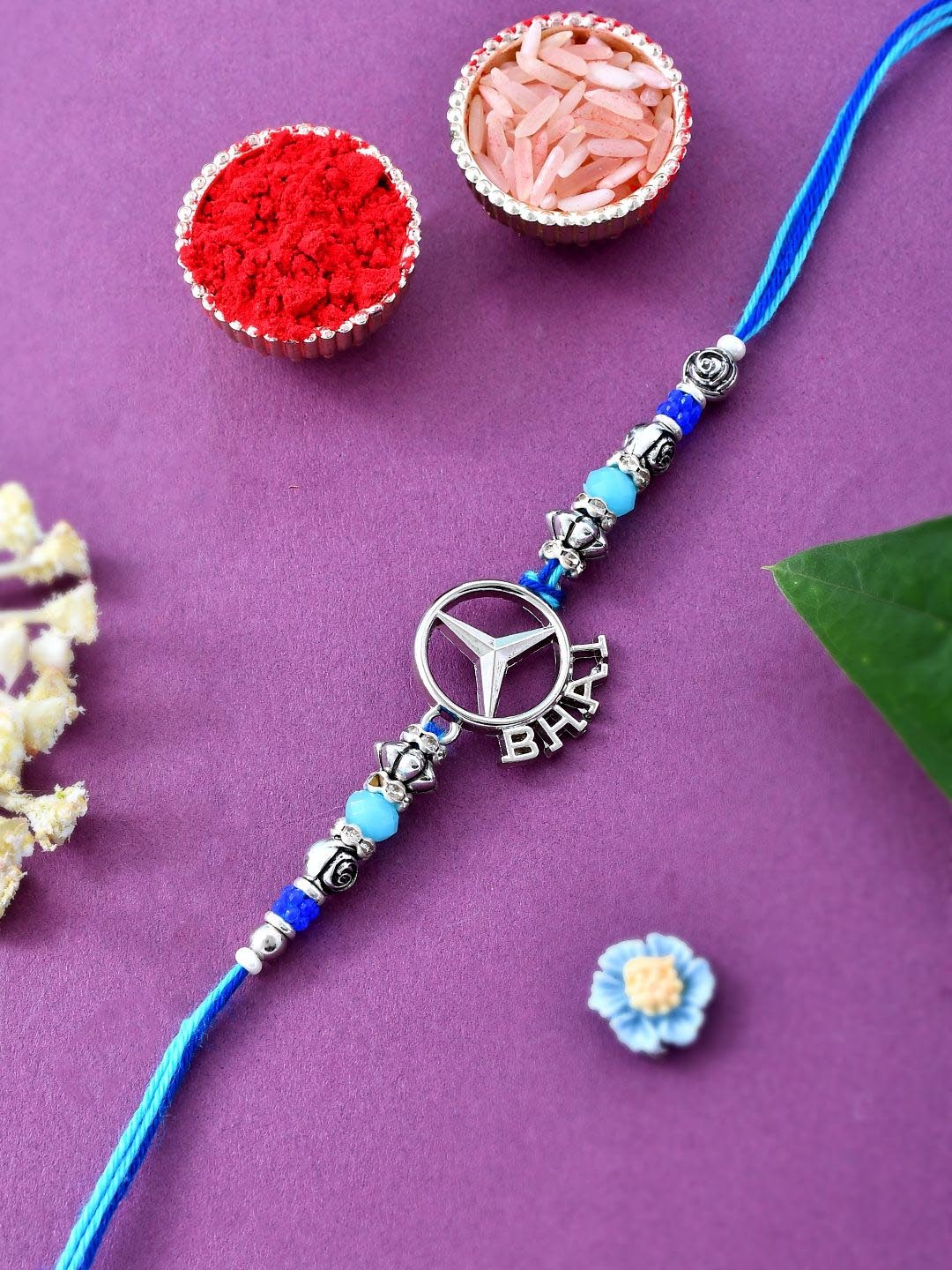 

Sangria Blue Mercedes Logo Bhai Charm Thread Rakhi With Greeting Card & Roli Chawal