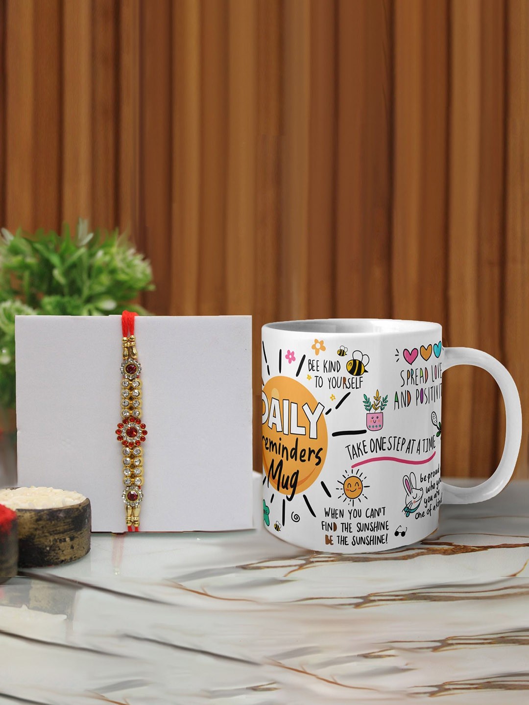 

Phirki Studio Set of 2 Stone Studded Thread Rakhi With Mugs & Roli Chawal, Red