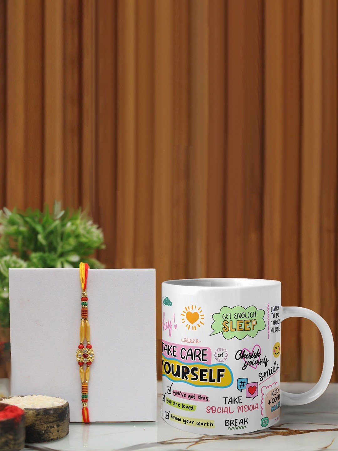 

Phirki Studio Set of 2 Stone Studded Thread Rakhi With Mugs & Roli Chawal, Yellow
