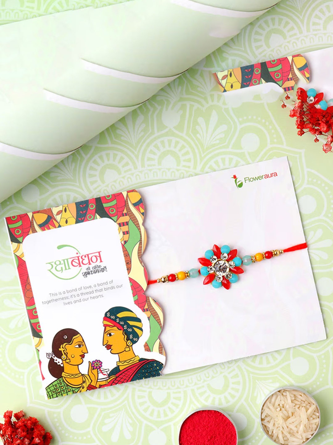 

Floweraura Stone Studded & Beaded Thread Rakhi With Roli Chawal, Red