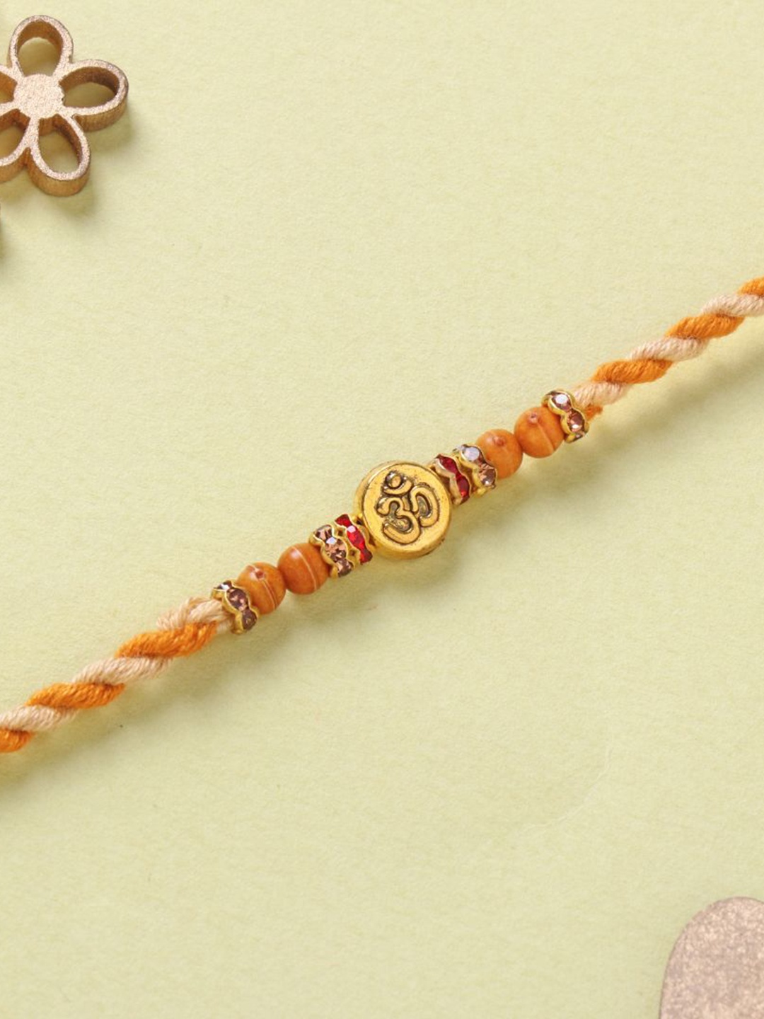 

Floweraura Serene Om Charm Beaded Thread Rakhi with Roli Chawal, Yellow